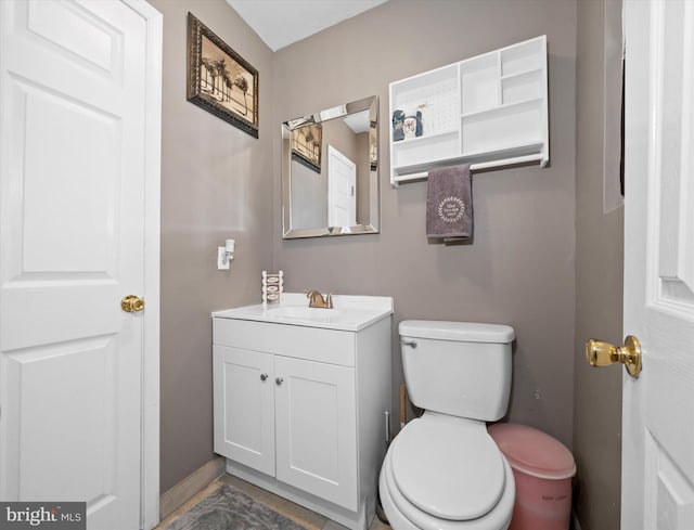 half bathroom with vanity and toilet