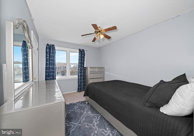 bedroom with baseboards, ceiling fan, and carpet floors