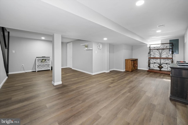 finished below grade area featuring recessed lighting, visible vents, baseboards, and wood finished floors