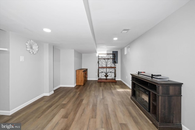 finished basement featuring visible vents, recessed lighting, baseboards, and wood finished floors