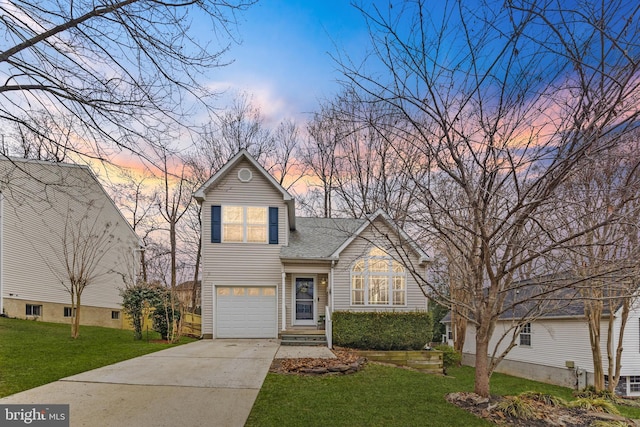 traditional home featuring a garage, roof with shingles, a lawn, and driveway