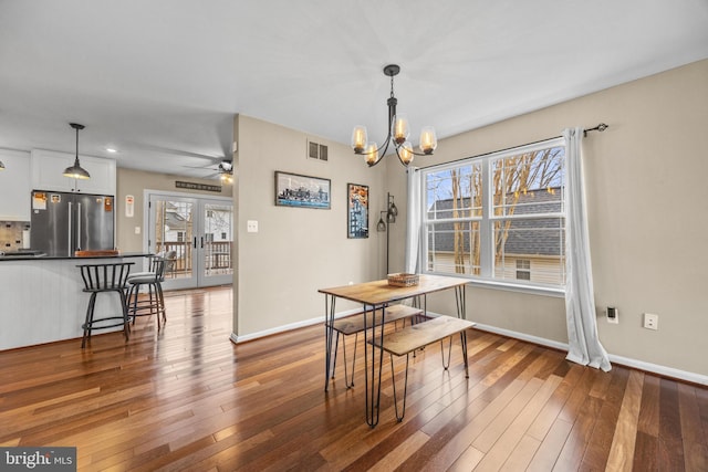 dining space featuring dark wood-style floors, french doors, visible vents, and baseboards