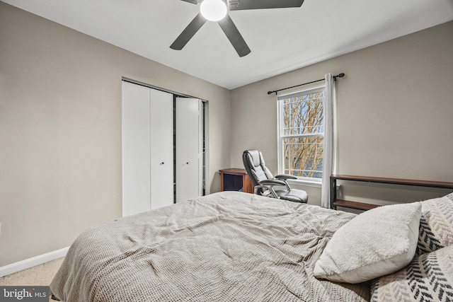 carpeted bedroom featuring a closet, a ceiling fan, and baseboards