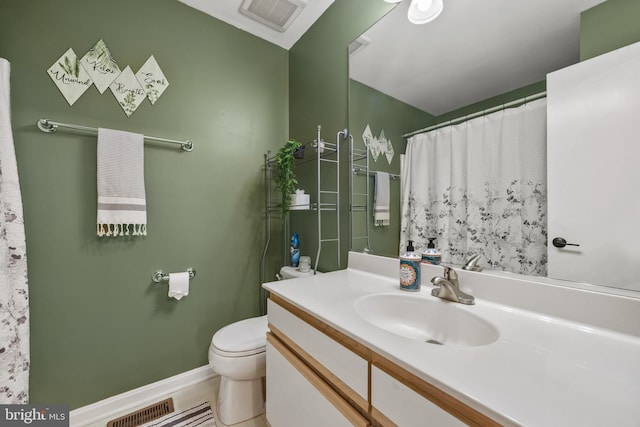 bathroom featuring baseboards, visible vents, vanity, and toilet