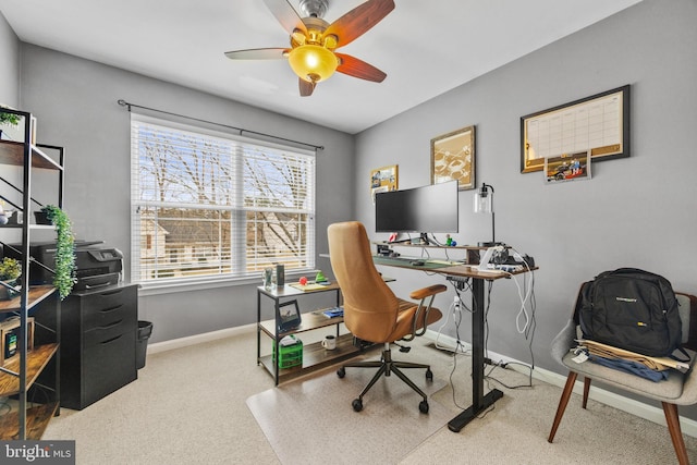 office area featuring a ceiling fan and baseboards