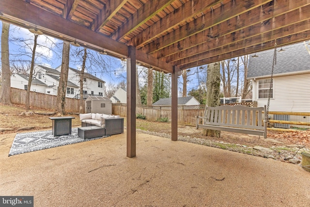 view of patio / terrace with an outbuilding, a fenced backyard, an outdoor living space, and a shed