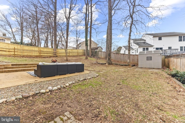 view of yard with an outbuilding, a storage shed, an outdoor hangout area, and a fenced backyard