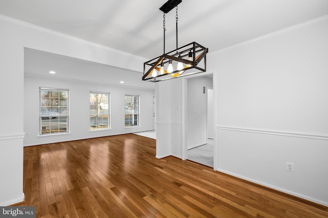 unfurnished dining area with recessed lighting, crown molding, baseboards, and hardwood / wood-style flooring