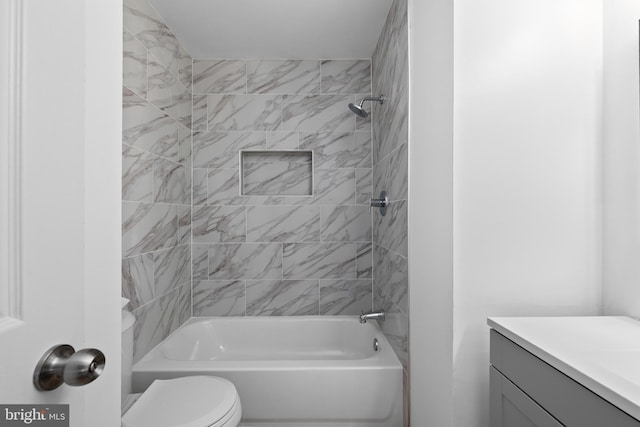 bathroom featuring vanity, shower / tub combination, and toilet