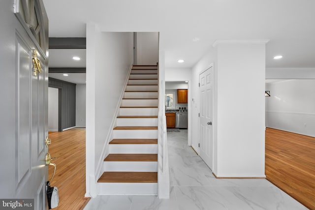 stairway with marble finish floor and recessed lighting