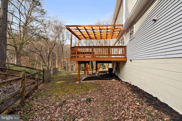 view of yard with fence, a deck, and a pergola