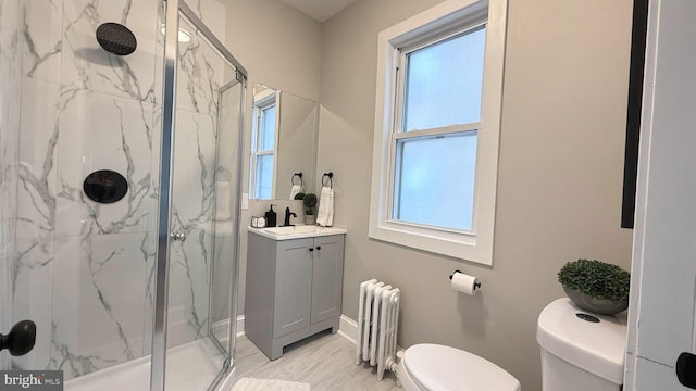 bathroom with a wealth of natural light, a marble finish shower, toilet, and radiator heating unit