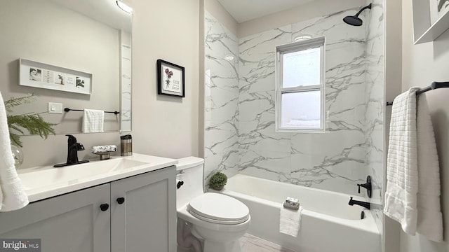 bathroom featuring marble finish floor, vanity, toilet, and bathtub / shower combination