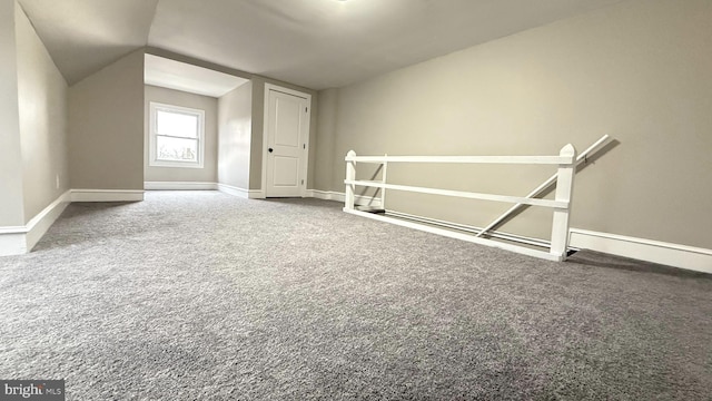 bonus room with lofted ceiling, carpet flooring, and baseboards