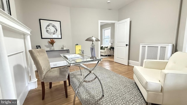 office area with baseboards and light wood finished floors