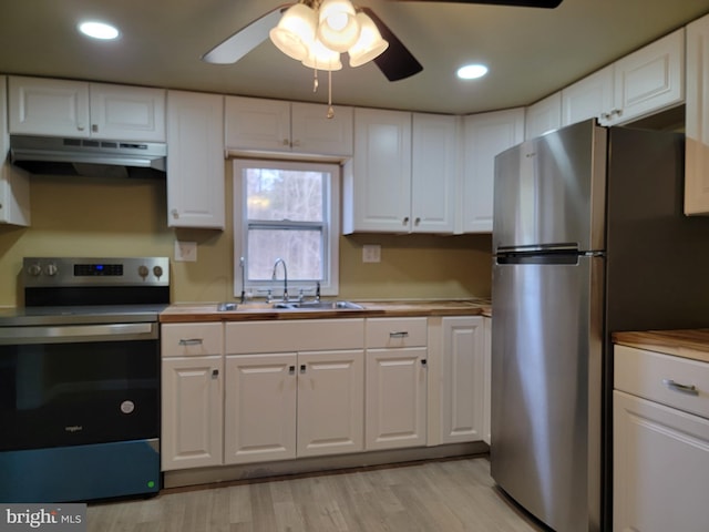 kitchen featuring stainless steel appliances, a sink, white cabinetry, and under cabinet range hood