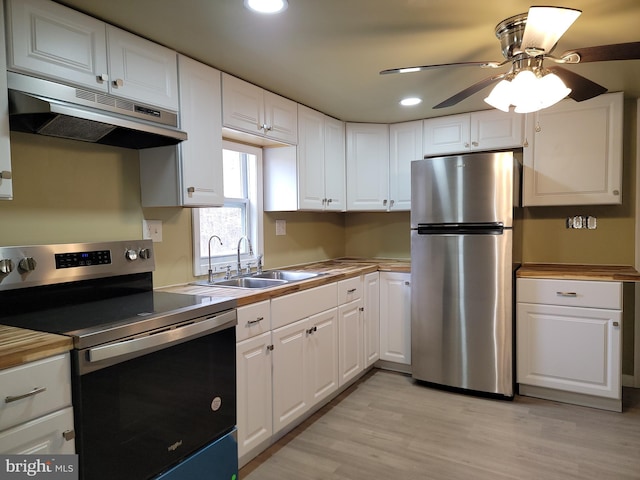 kitchen featuring appliances with stainless steel finishes, a sink, white cabinetry, and under cabinet range hood