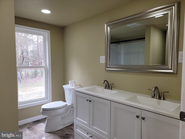 bathroom featuring a healthy amount of sunlight, a sink, and visible vents