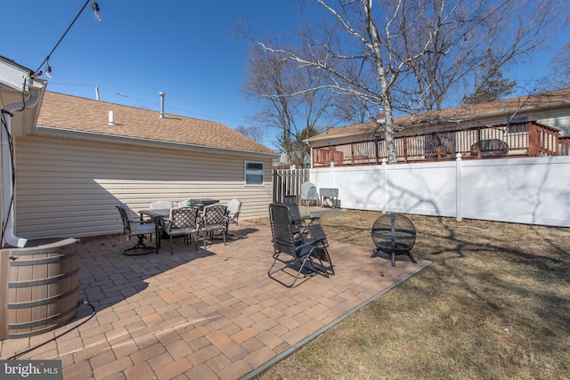 view of patio / terrace featuring outdoor dining area, a fire pit, and fence