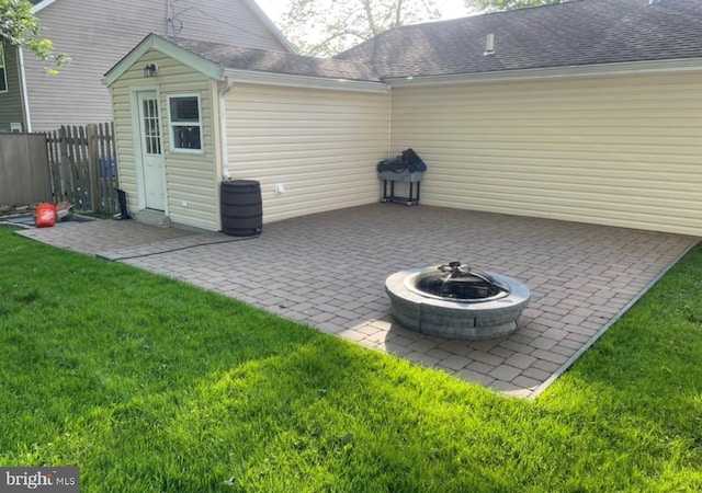 view of patio featuring a fire pit and fence