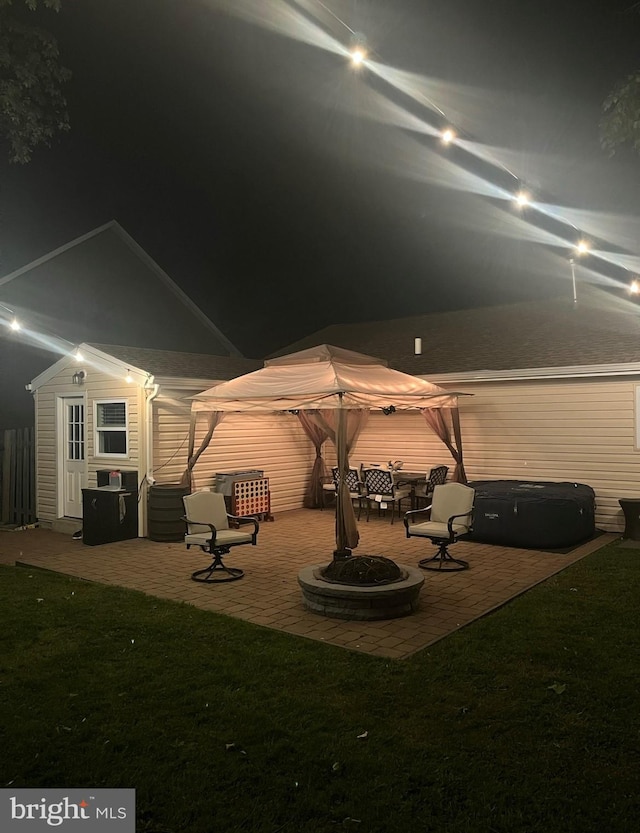 back of house at twilight with a yard and a patio