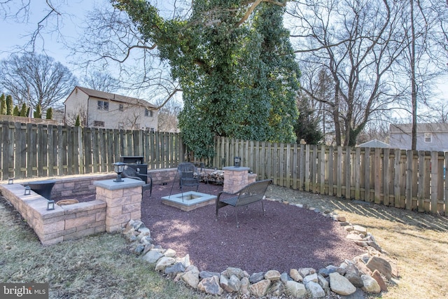 view of yard with an outdoor fire pit and a fenced backyard