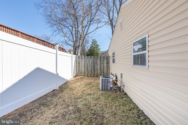 view of yard featuring central AC unit and a fenced backyard