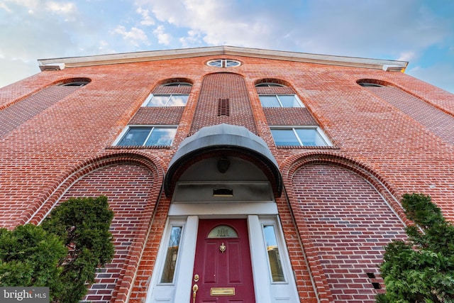 doorway to property with brick siding