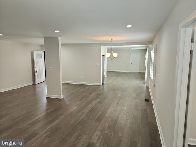 interior space with an inviting chandelier, baseboards, dark wood-style floors, and recessed lighting
