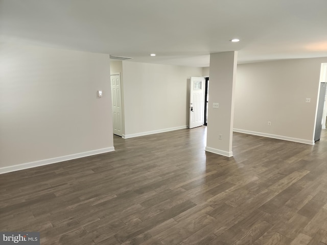 below grade area featuring dark wood-style flooring, baseboards, and recessed lighting