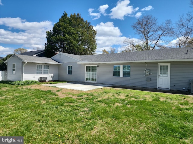 rear view of property with a patio, a shingled roof, and a lawn