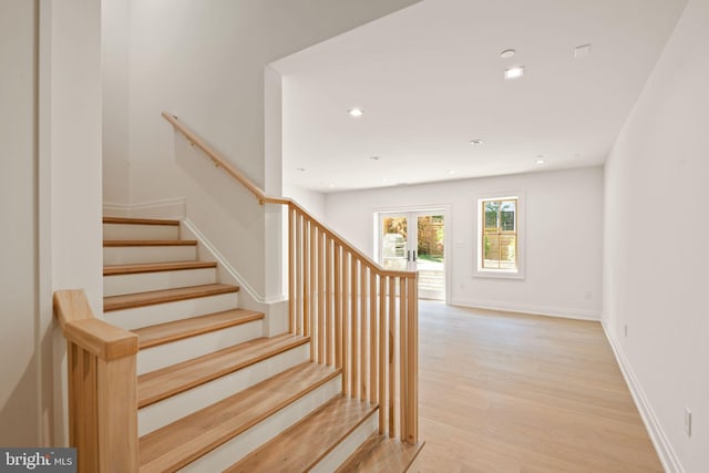 stairs featuring baseboards, french doors, wood finished floors, and recessed lighting