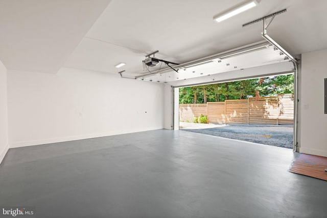 garage featuring baseboards, electric panel, and a garage door opener