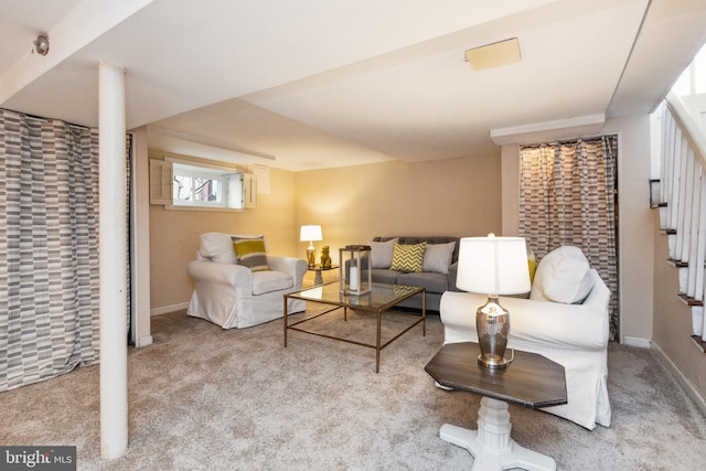 carpeted living room featuring baseboards