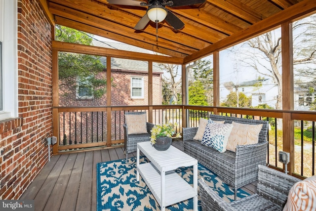 wooden deck with an outdoor living space and ceiling fan