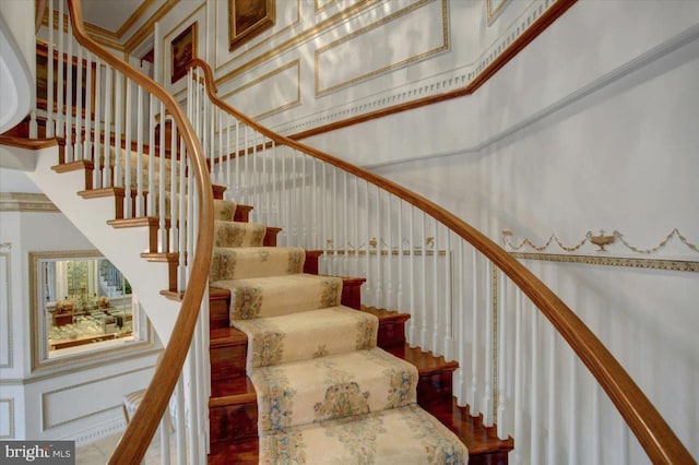 stairway featuring a high ceiling