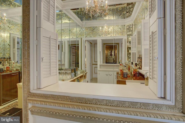 bathroom with a notable chandelier and wallpapered walls