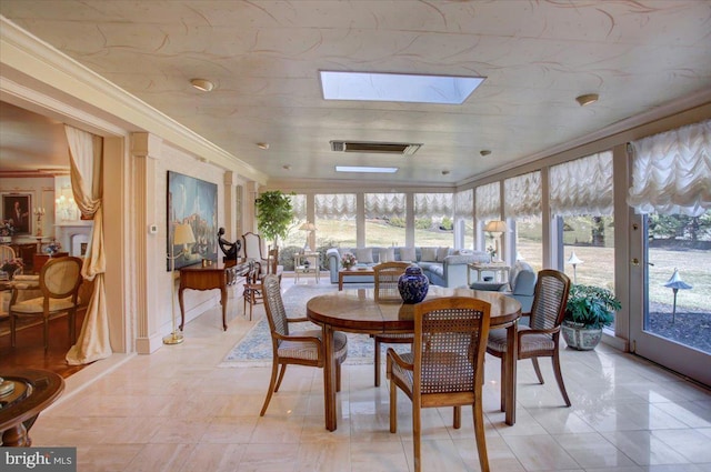 sunroom / solarium with a skylight and visible vents