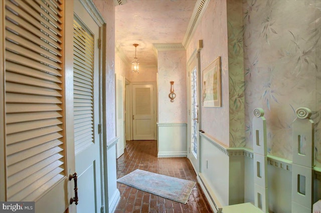 corridor with brick floor, wallpapered walls, and a wainscoted wall