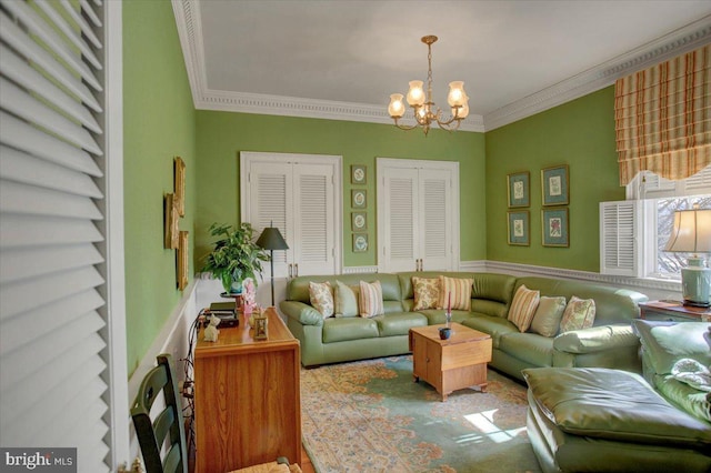 living area with an inviting chandelier and crown molding