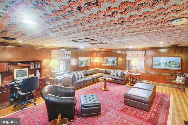 living area featuring a baseboard heating unit, ornamental molding, and wood walls