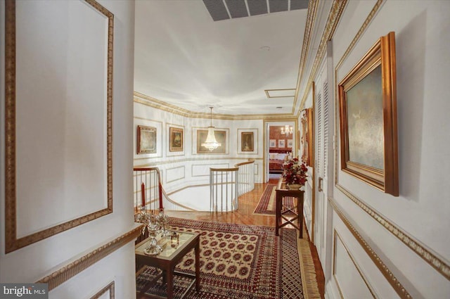 hallway featuring ornamental molding and visible vents