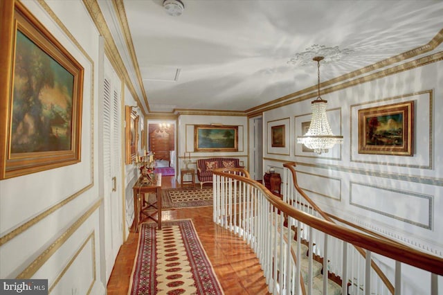 hall featuring ornamental molding and a notable chandelier