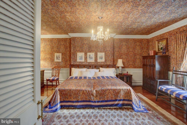 bedroom with ornamental molding, wainscoting, and wallpapered walls