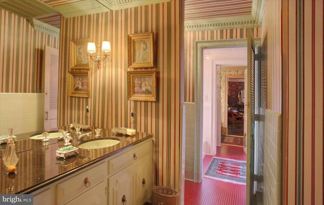 bathroom featuring vanity and wallpapered walls