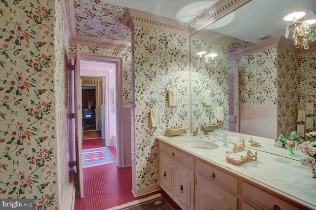 bathroom with visible vents, a notable chandelier, vanity, and wallpapered walls