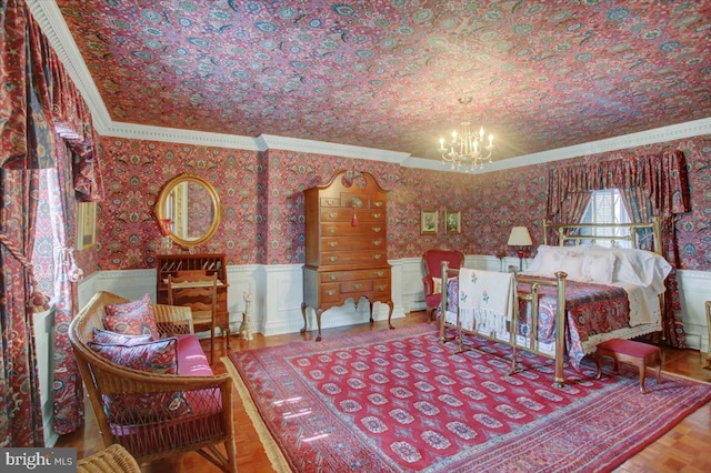 bedroom featuring a wainscoted wall, ornamental molding, a notable chandelier, and wallpapered walls