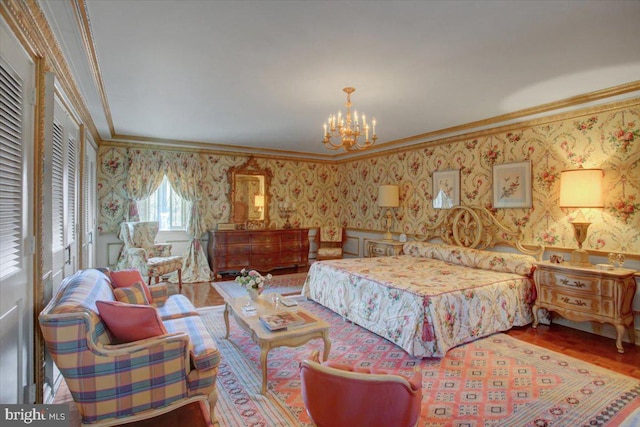 bedroom featuring a chandelier, wood finished floors, crown molding, and wallpapered walls