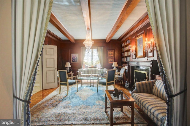 living area with wood walls, a fireplace, and beamed ceiling