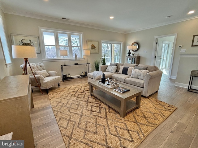 living area featuring light wood-type flooring, visible vents, and ornamental molding